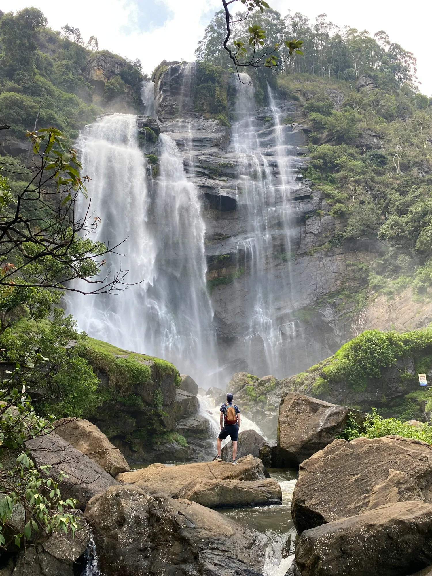Traveller standing near a waterfall in Sri Lanka